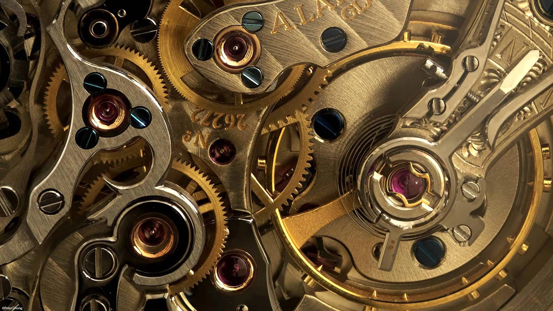 Close view of the brass gears and jewels inside a mechanical watch movement