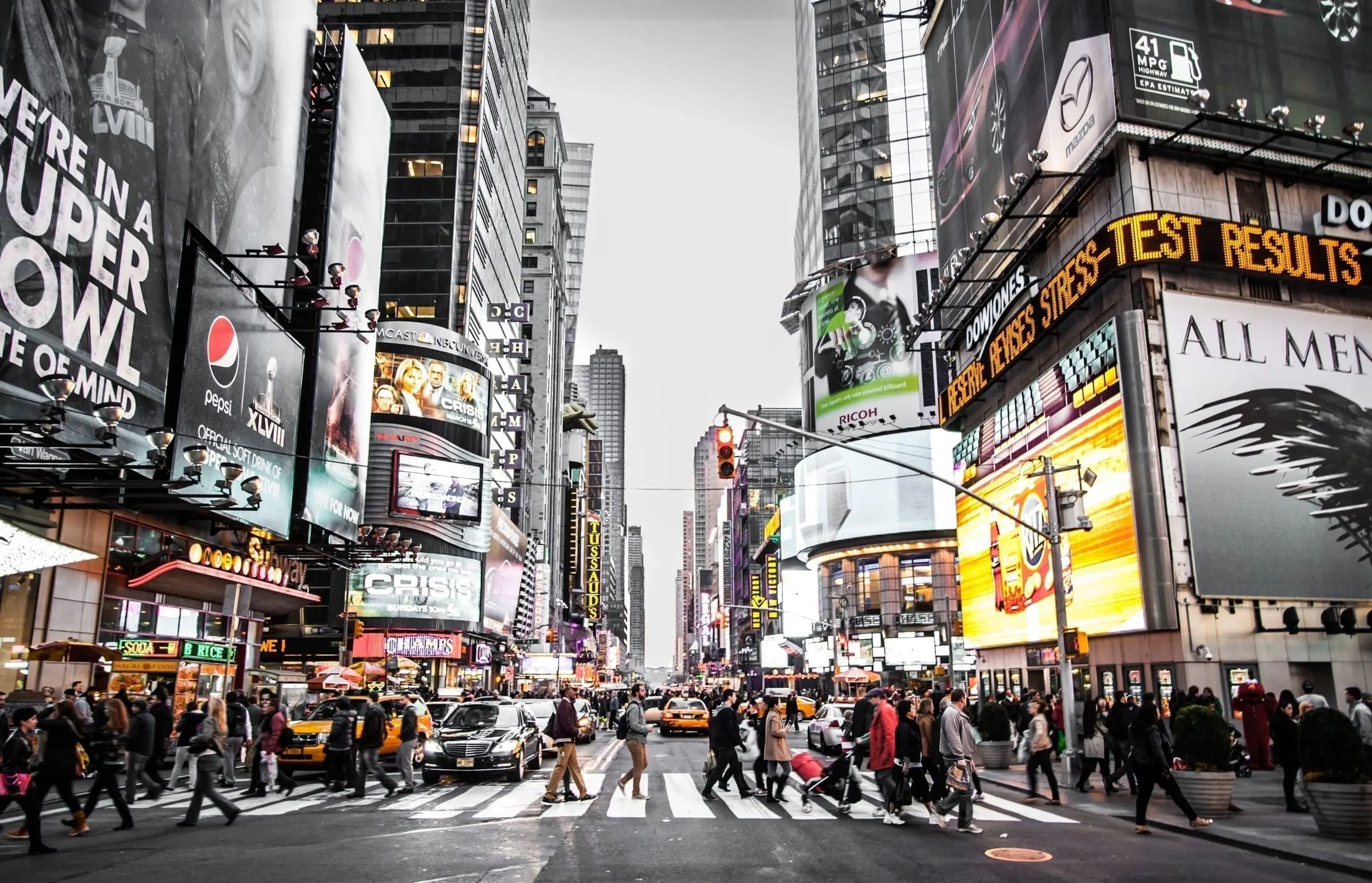 Crowds and billboards at a busy Times Square intersection