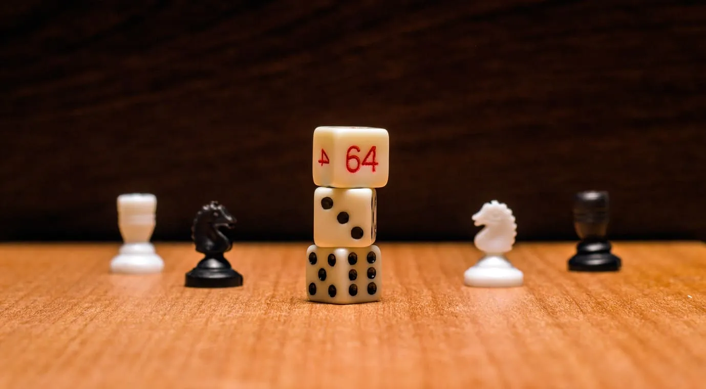 A stack of dice showing 64 standing among chess pieces on a wooden board