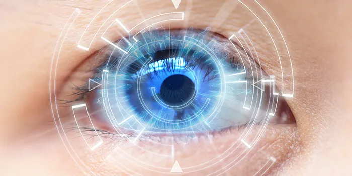 Close view of a blue eye overlaid with a glowing scanning interface
