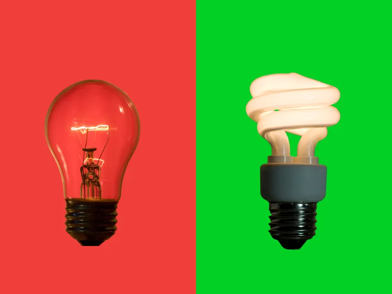 An incandescent bulb on a red background beside a compact fluorescent bulb on a green background