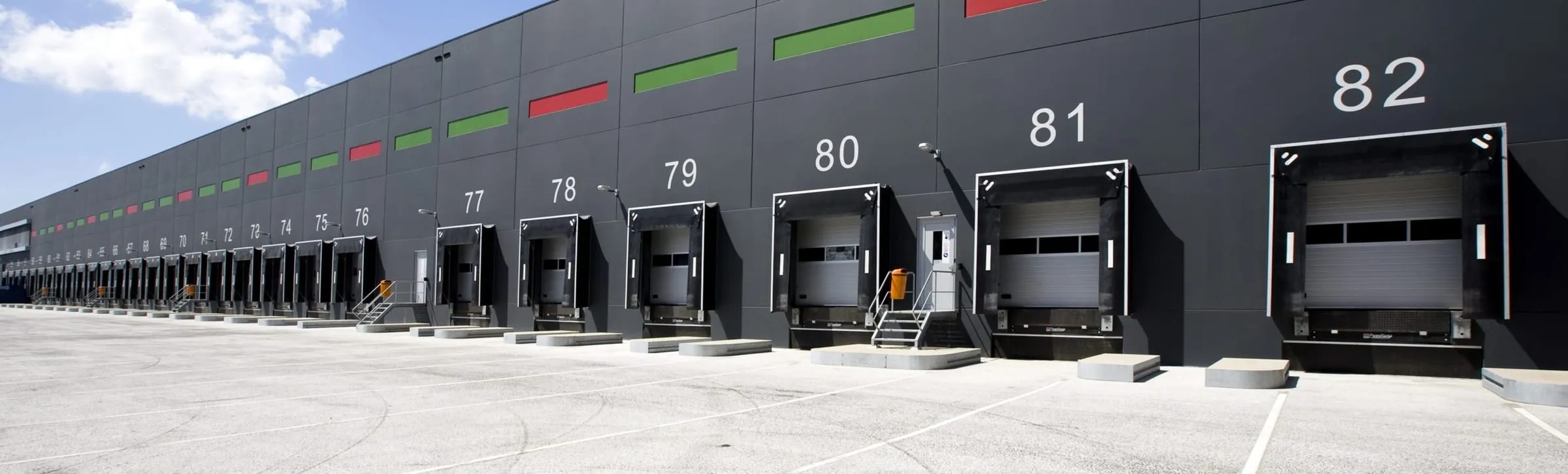 A row of numbered loading bays along the side of a distribution warehouse
