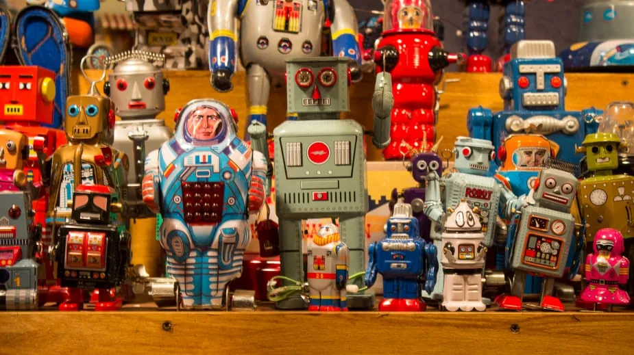 Shelves crowded with vintage tin robot toys
