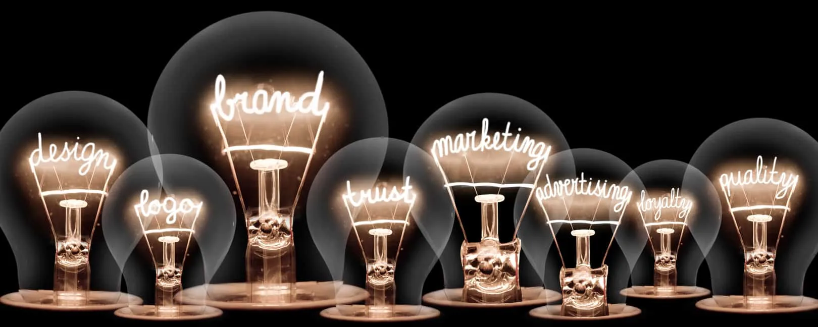 A row of lit filament bulbs whose filaments spell brand, design, logo, trust and marketing