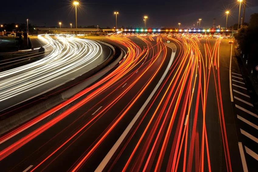 Long exposure of red and white light trails along a motorway at night