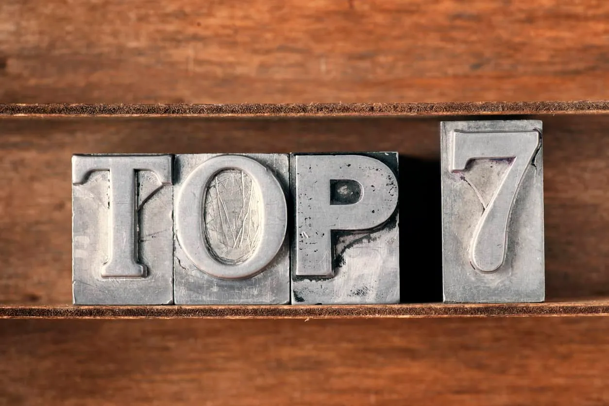 The words top 7 set in metal letterpress type on a wooden tray