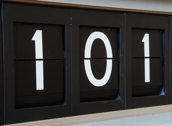 A large split-flap display showing the number 101