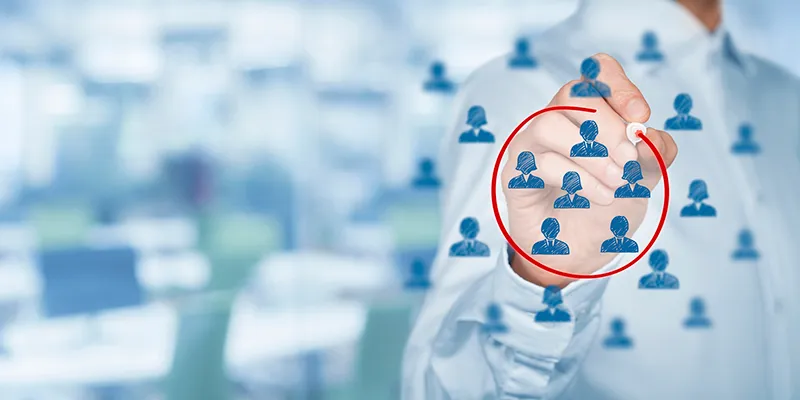 A hand circling one figure in a grid of user icons