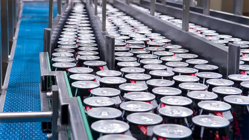 Rows of drink cans moving along a production line