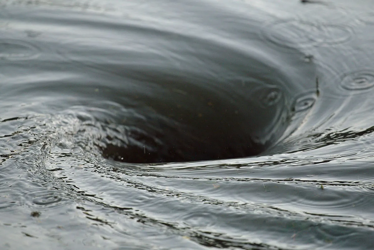 A whirlpool spinning in dark water