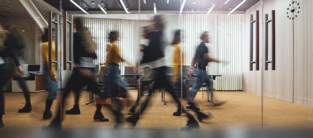 Businesspeople walking at modern office. Motion blur.